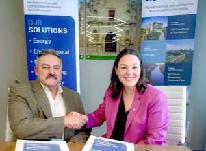 Halff's President and CEO Jessica Baker Daily signing purchase acquisition agreement with C&D Utility Consulting's Romeo Cabrera